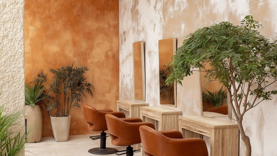 Warm-toned salon interior with plants at Jeremy's Salon, London, England, GB.