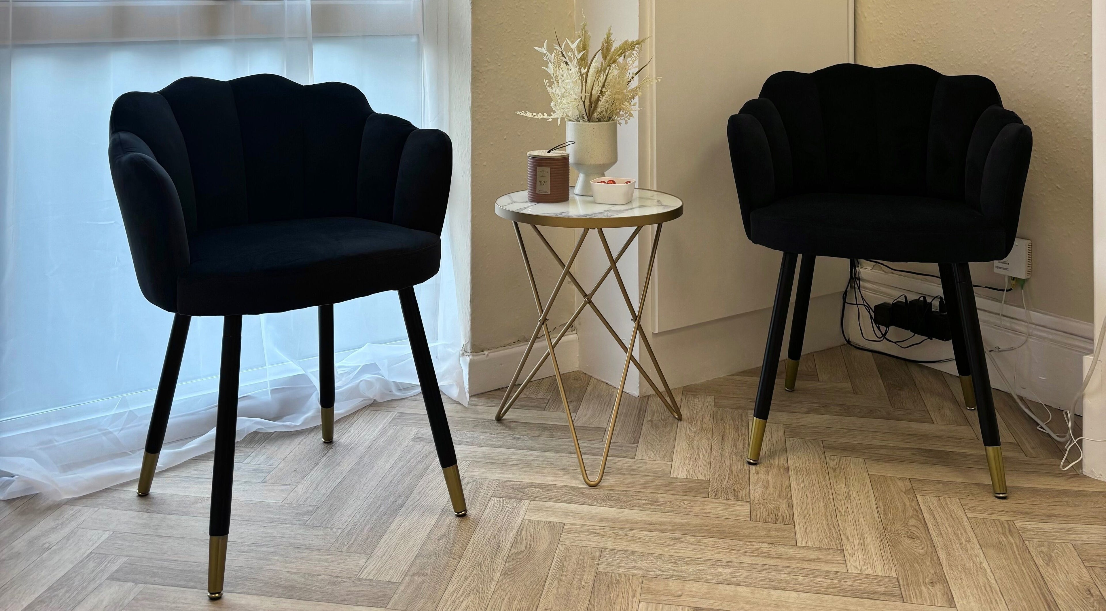 Chic black chairs with a gold-accented table at The Glitter Room, Cannock, England, GB.