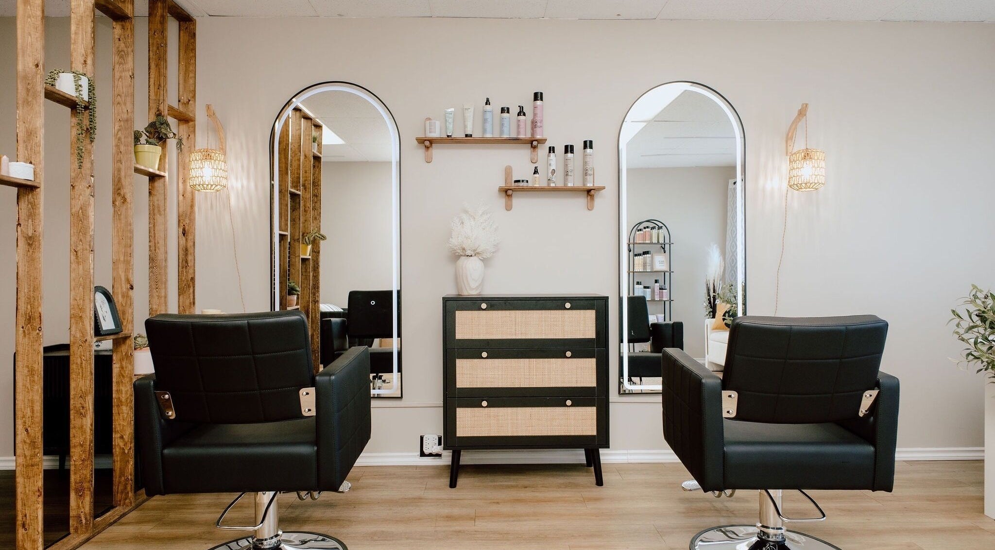 Modern salon chairs and mirrors at Beauty By BK, Sault Ste. Marie, Ontario, CA, offering chic wellness services.