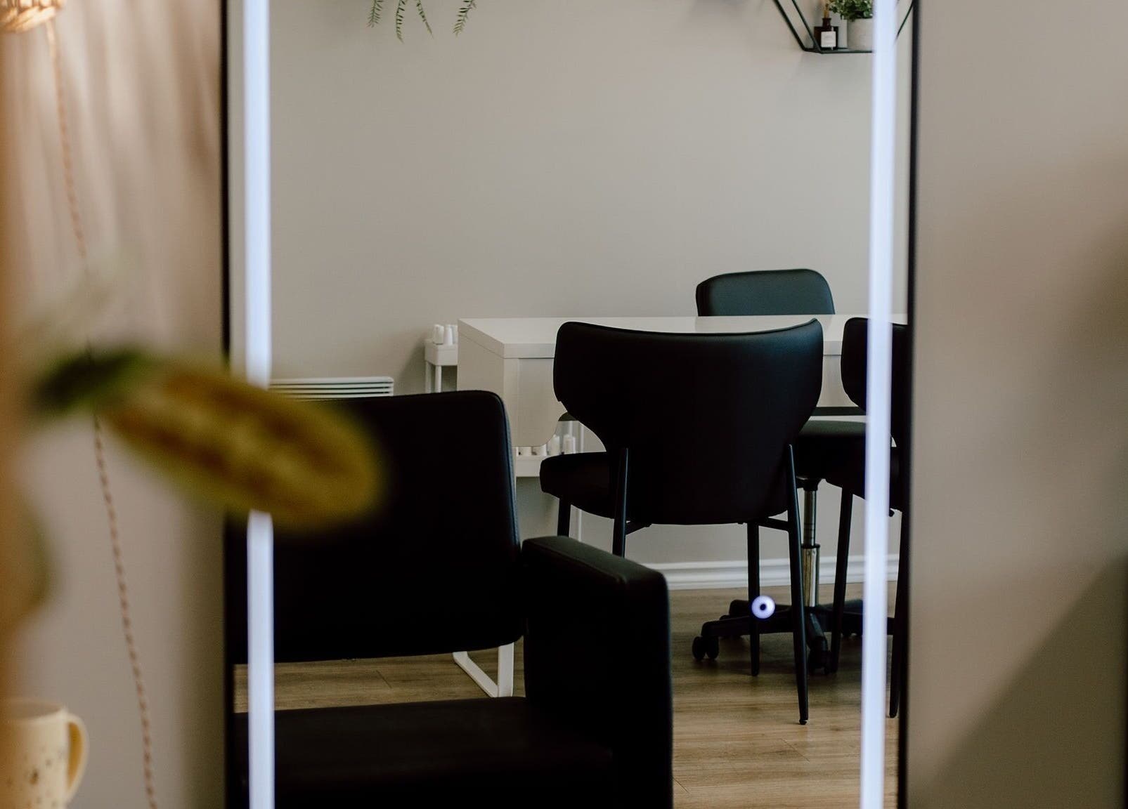 Elegant seating area at Beauty By BK in Sault Ste. Marie, Ontario, CA, showcasing modern chairs and decor.