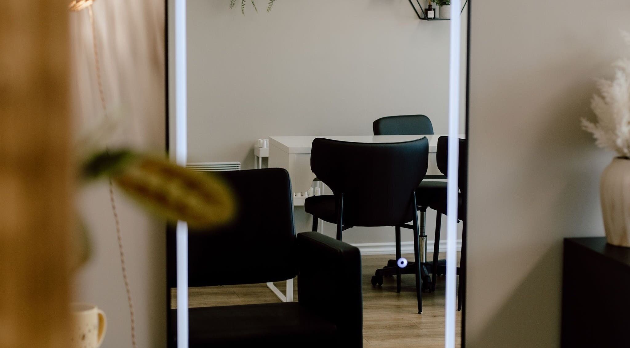 Elegant seating area at Beauty By BK in Sault Ste. Marie, Ontario, CA, showcasing modern chairs and decor.