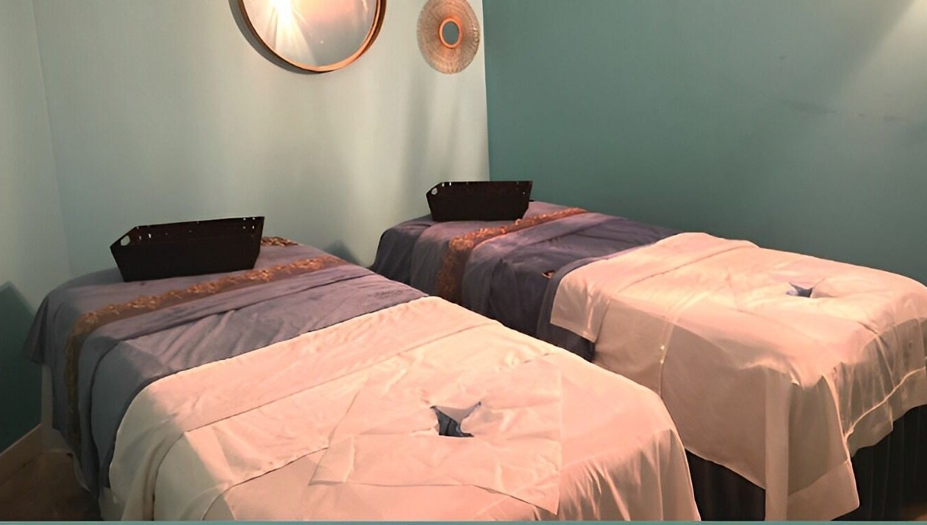Relaxing massage room at Acqua Spa in Orlando, Florida, US with two massage tables and calming decor.