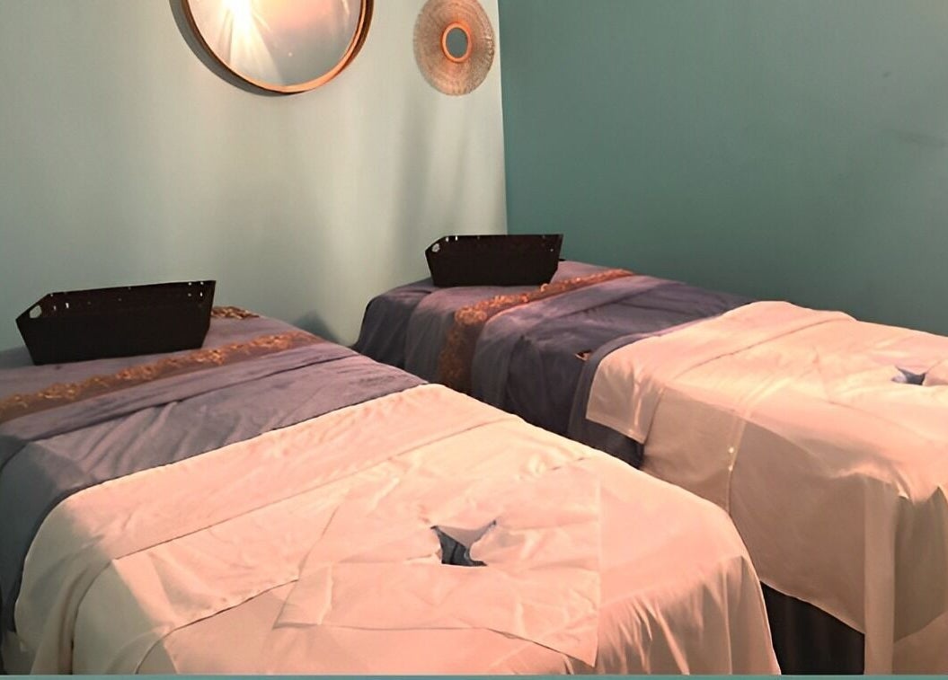 Relaxing massage room at Acqua Spa in Orlando, Florida, US with two massage tables and calming decor.