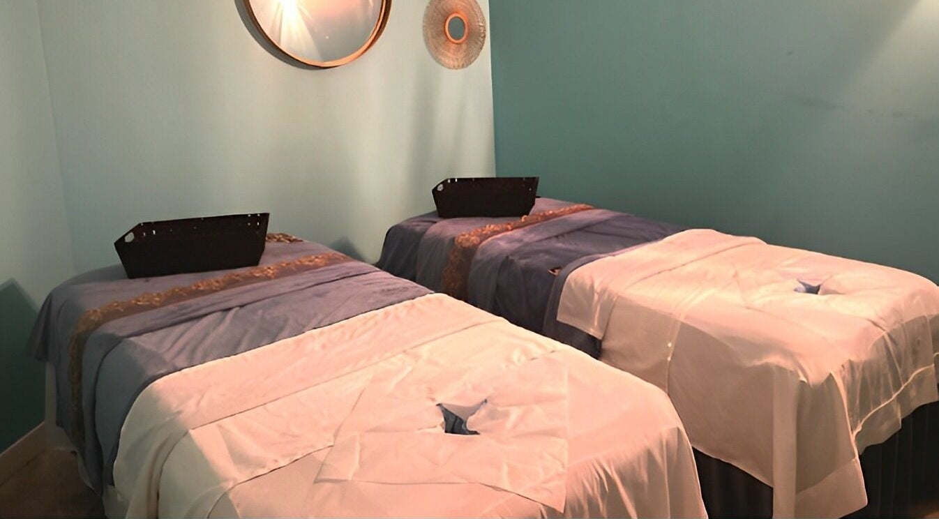 Relaxing massage room at Acqua Spa in Orlando, Florida, US with two massage tables and calming decor.