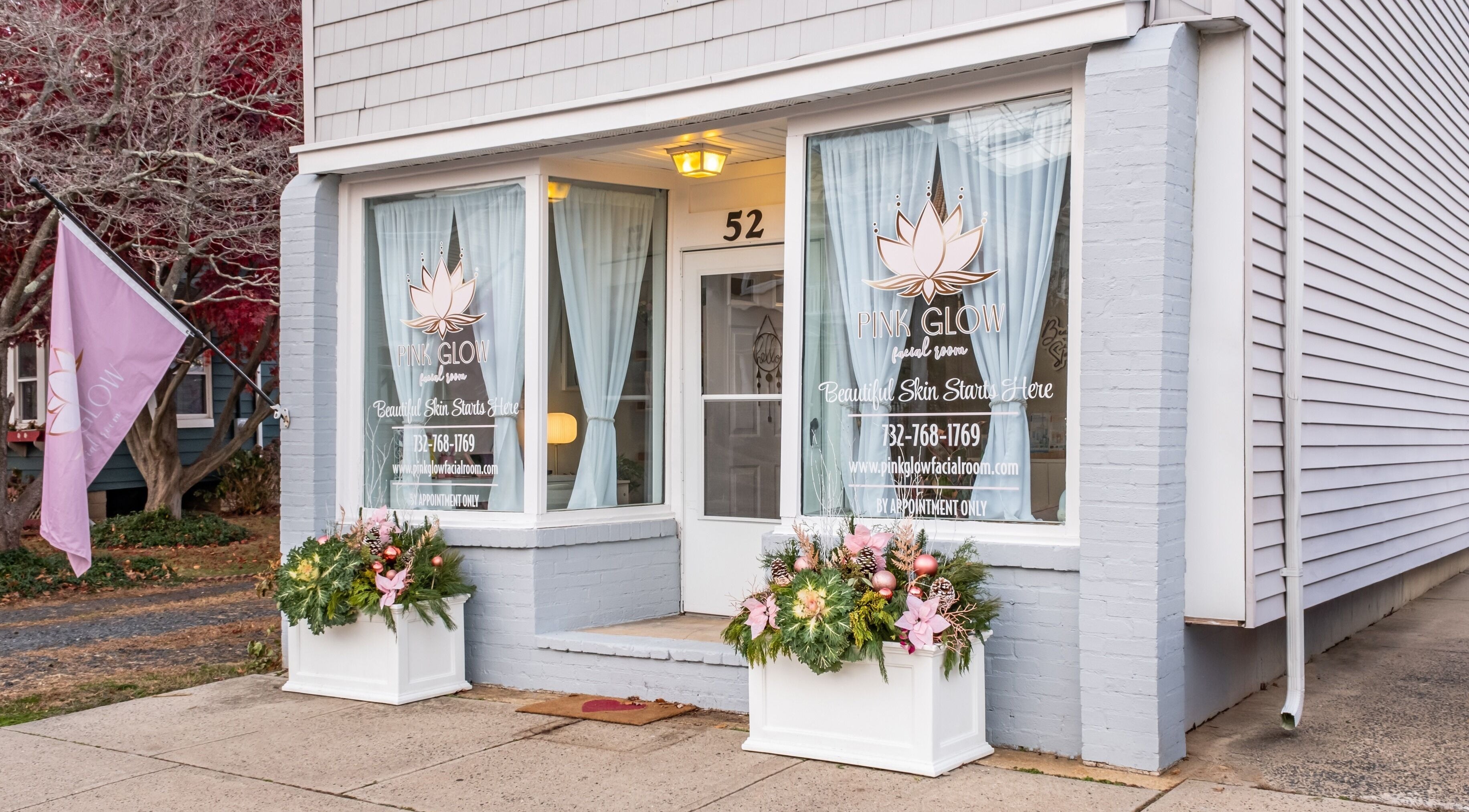 Charming exterior of Pink Glow Facial Room in Manasquan, New Jersey, US featuring elegant signage and decor.