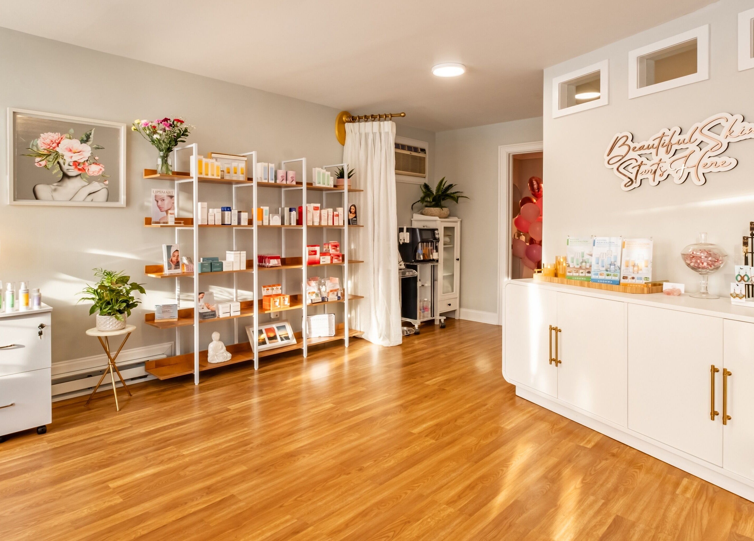 Elegant interior of Pink Glow Facial Room in Manasquan, New Jersey, US with skincare products on display.