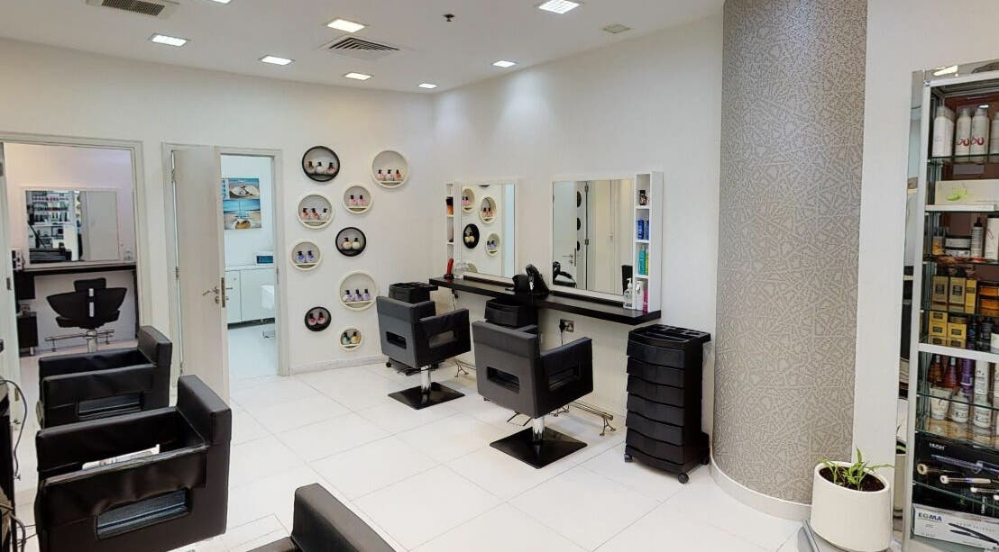 Modern makeup station at La Reine Beauty Center, Abu Dhabi, AE. Sleek salon chairs and elegant decor.
