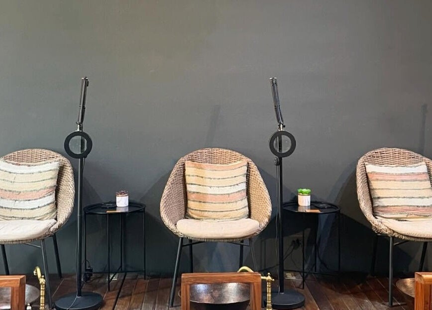 Sillas de mimbre y mesas en Younik Tulum, Quintana Roo, MX, creando un ambiente acogedor y moderno.