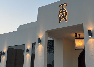 Elegant facade of The Space Beauty Lounge in أبوظبي, Abu Dhabi, AE illuminated at dusk.