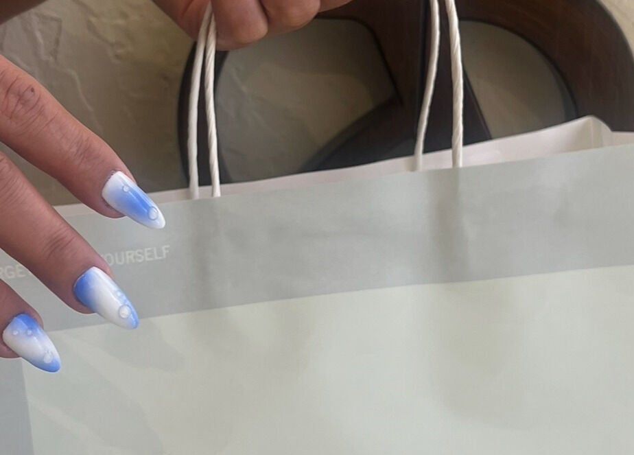 Elegant blue and white nails at The Space Beauty Lounge, أبوظبي, Abu Dhabi, AE, paired with a stylish bag.