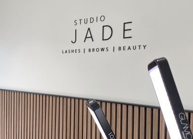 Interior view of Jade Lashes Brows Beauty Studio, Baston, England, GB, featuring a sleek modern sign.