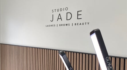 Interior view of Jade Lashes Brows Beauty Studio, Baston, England, GB, featuring a sleek modern sign.