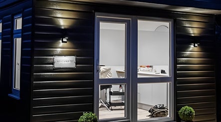 Night view of Jade Lashes Brows Beauty Studio entrance in Baston, England, GB.