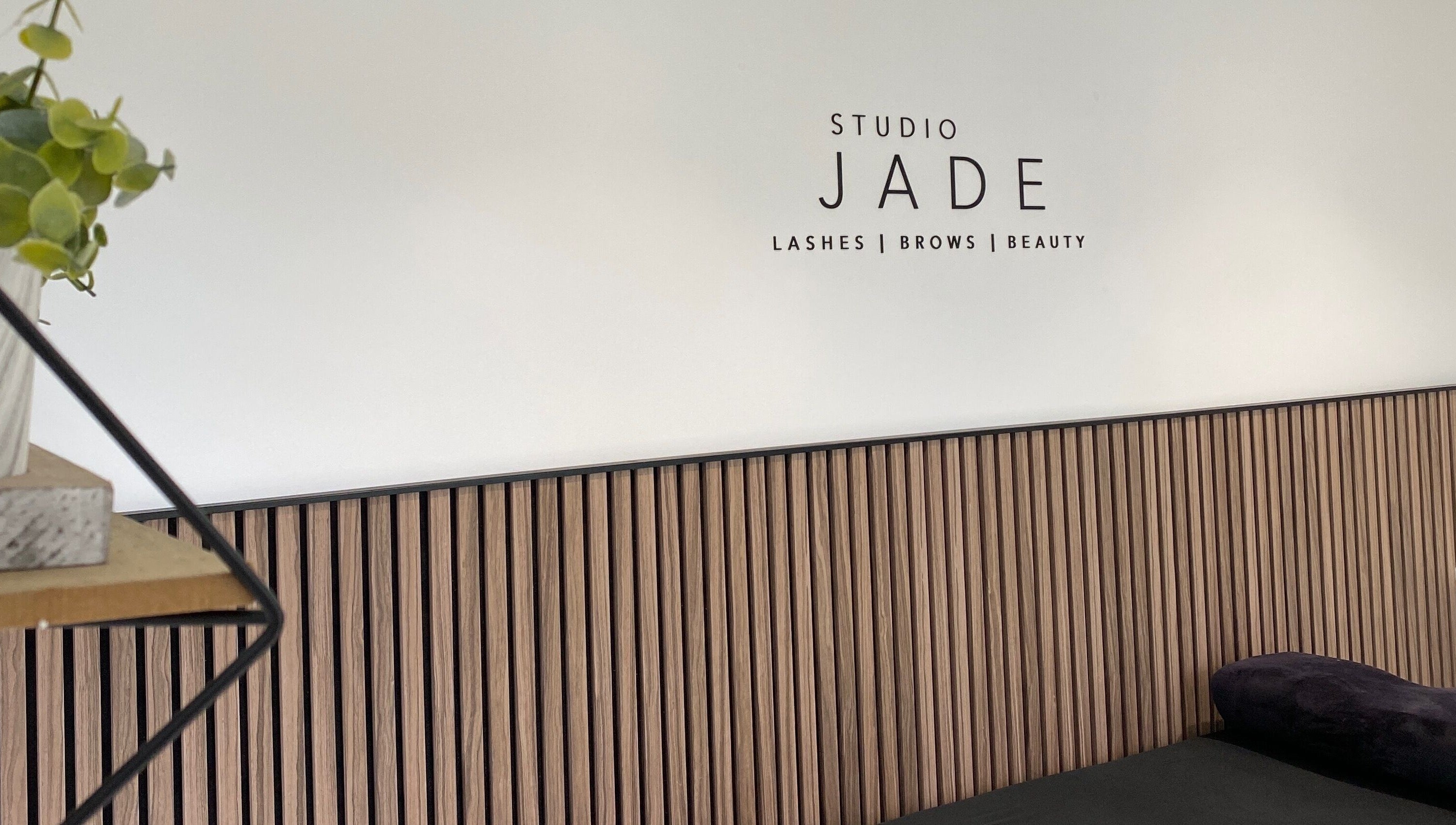 Interior view of Jade Lashes Brows Beauty Studio, Baston, England with sleek wooden decor and modern design.