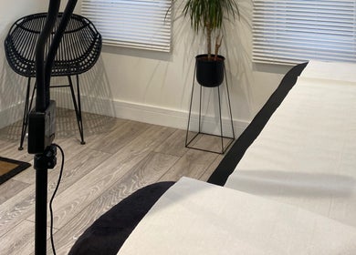 Modern room at Jade Lashes Brows Beauty Studio, Baston, England with a chic chair and plant arrangement.