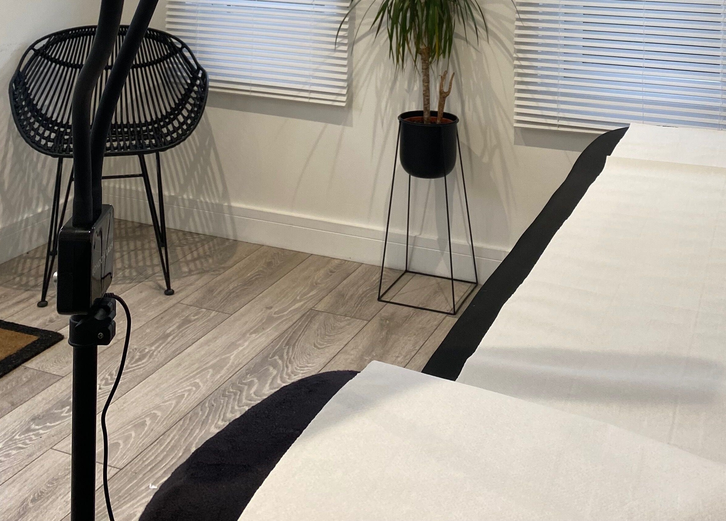 Modern room at Jade Lashes Brows Beauty Studio, Baston, England with a chic chair and plant arrangement.