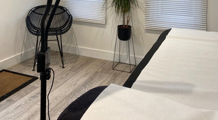 Modern room at Jade Lashes Brows Beauty Studio, Baston, England with a chic chair and plant arrangement.