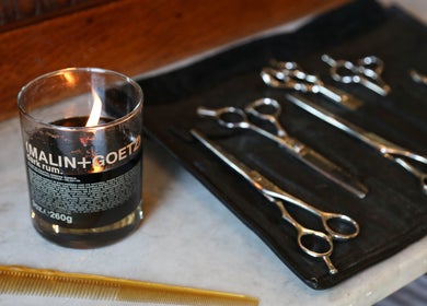 Grooming tools and lit candle at Bar•Ber in Cold Spring, New York, US for a relaxing experience.