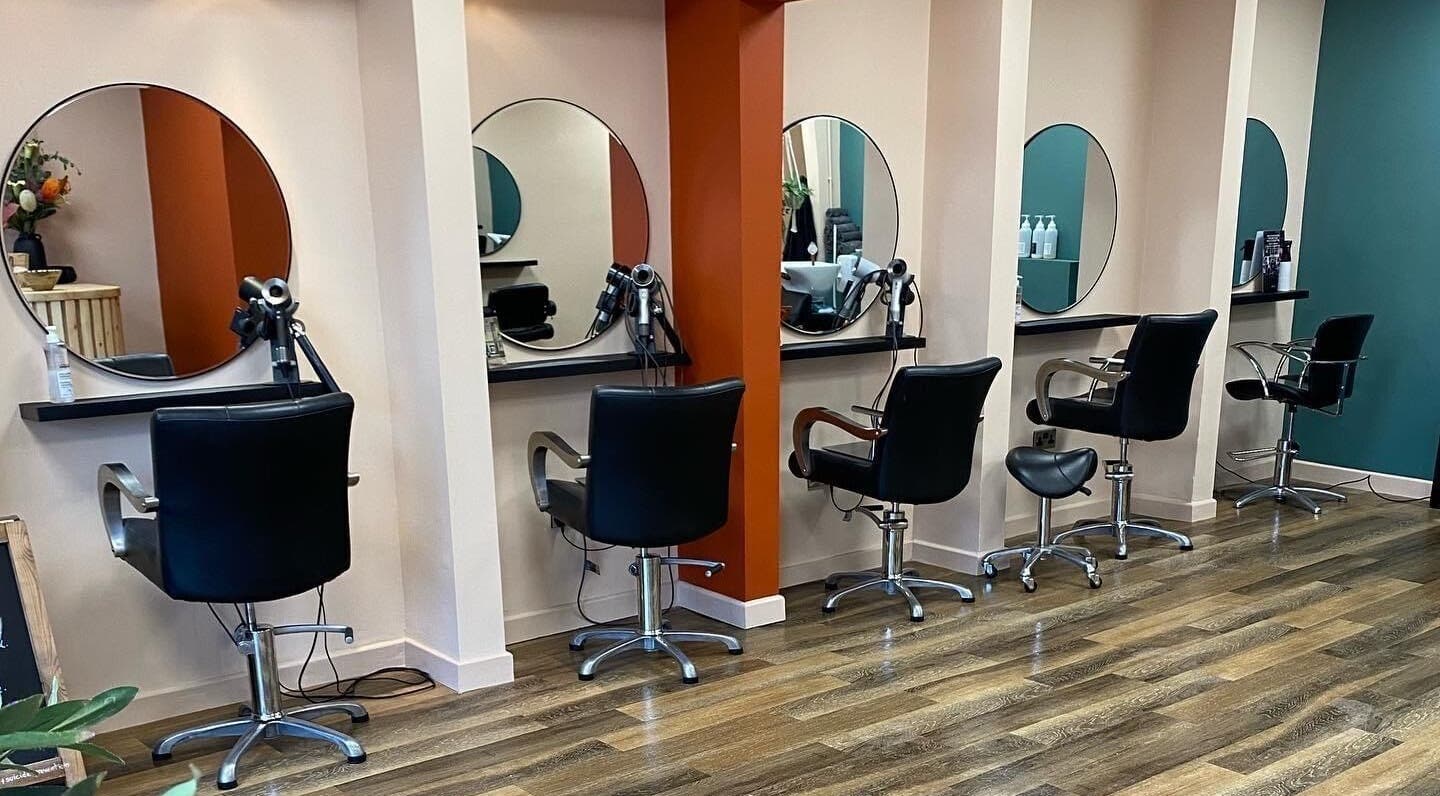 Modern salon chairs and mirrors at Ona Hair Artistry, Stoke-on-Trent, England, GB, highlighting a stylish interior.