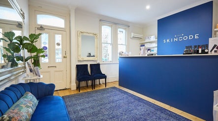 Reception area of The Skin Code By Bronzalicious in North Sydney, New South Wales, AU with stylish blue decor.