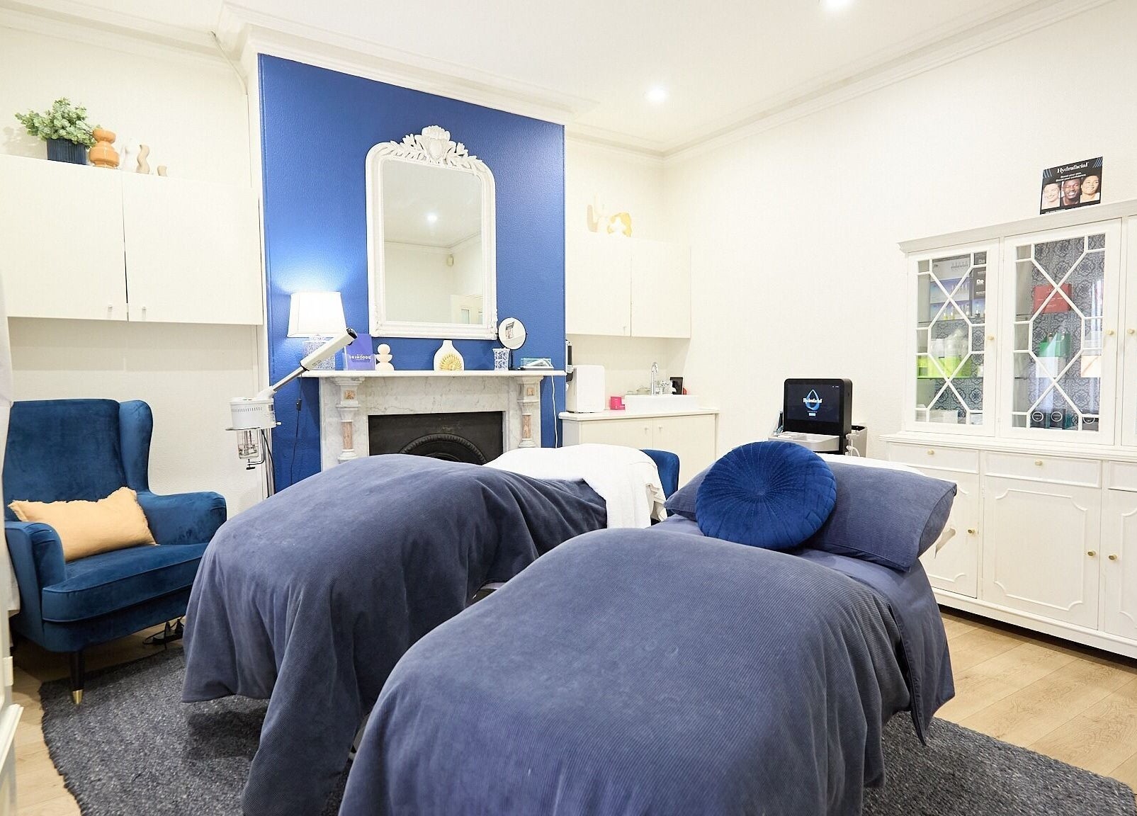 Luxurious spa room at The Skin Code By Bronzalicious in North Sydney, New South Wales, AU with plush blue decor.