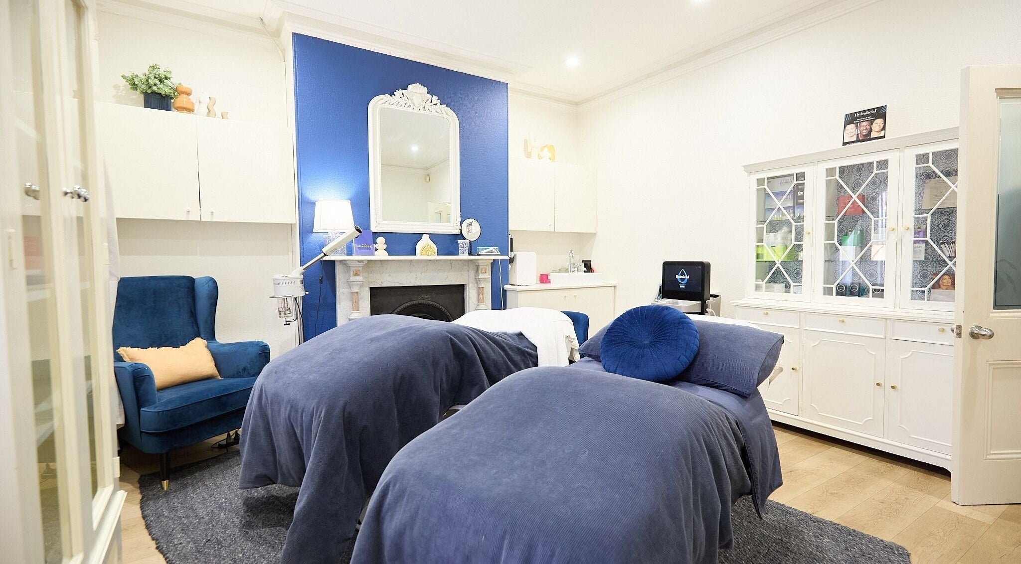 Luxurious spa room at The Skin Code By Bronzalicious in North Sydney, New South Wales, AU with plush blue decor.
