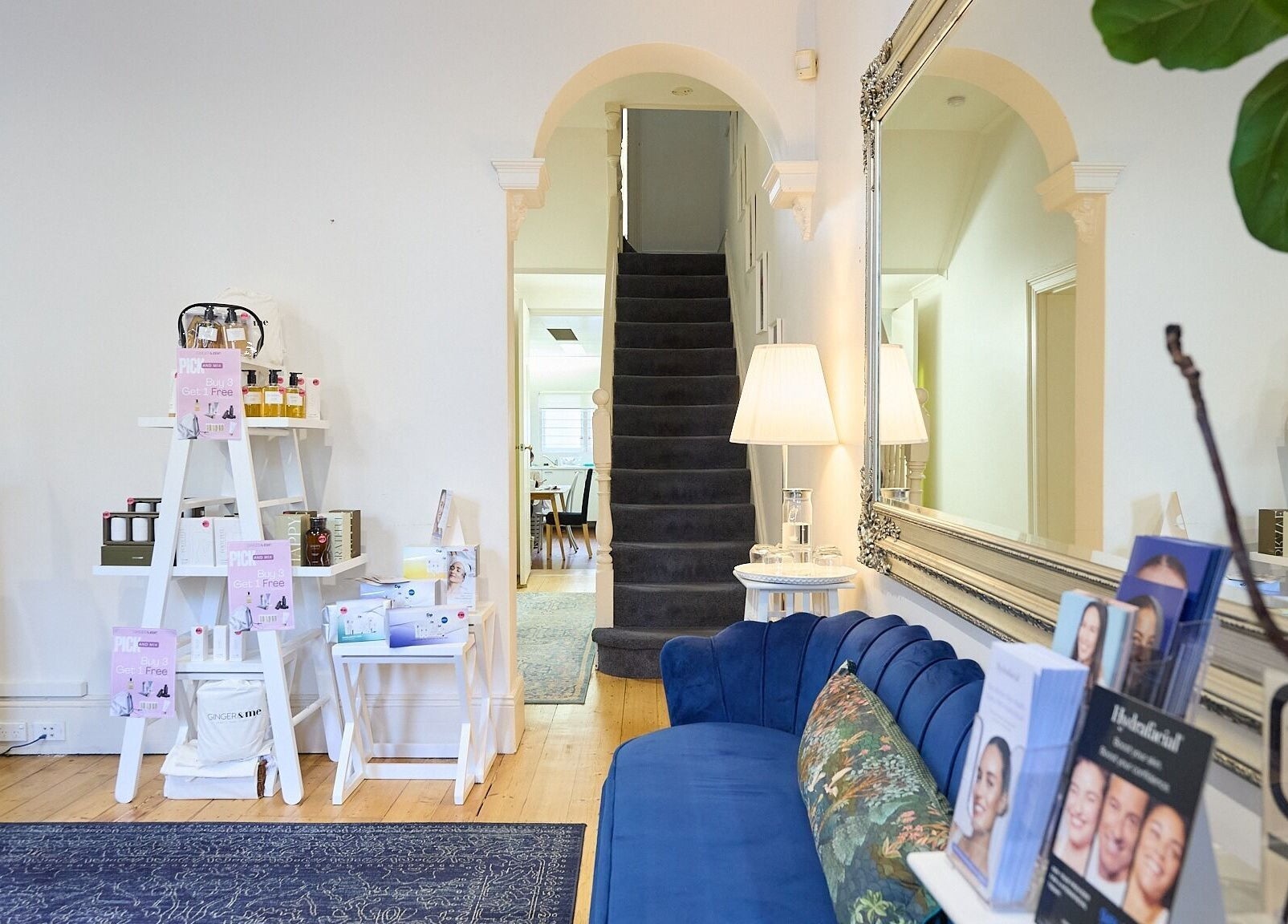 Inviting reception at The Skin Code By Bronzalicious, North Sydney, NSW, AU, showcasing a cozy blue sofa and decor.