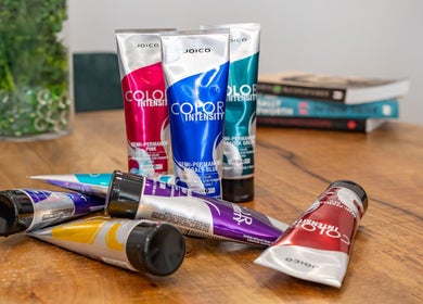 Vibrant hair color tubes at Hideaway Hair, Moffat Beach, Queensland, AU, showcasing diverse shades for creative styles.