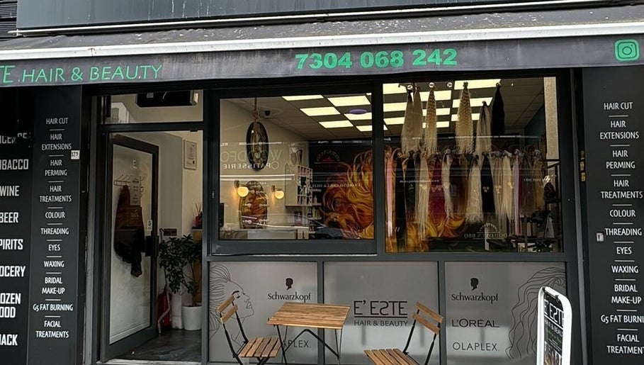 Street view of E'este Hair & Beauty salon in London, England, GB with stylish window displays.