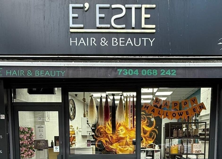 Front view of E'este Hair & Beauty showcasing vibrant window art in London, England, GB.