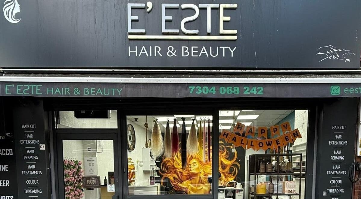 Front view of E'este Hair & Beauty showcasing vibrant window art in London, England, GB.