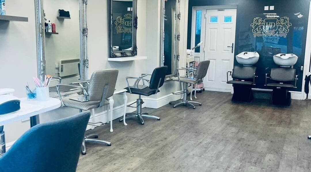 Spacious salon interior at The Hairdressers Marie in Cadishead, England, GB with chic styling chairs and mirrors.