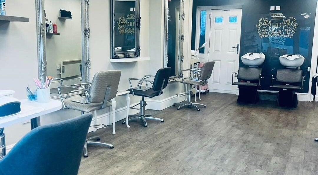 Spacious salon interior at The Hairdressers Marie in Cadishead, England, GB with chic styling chairs and mirrors.
