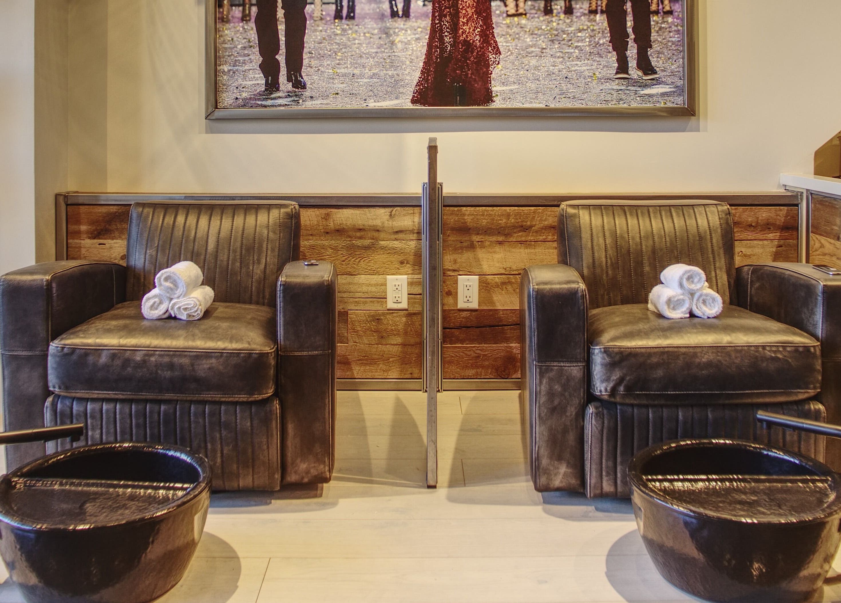 Upscale pedicure chairs and basins at Menicure Queen West in Toronto, Ontario, CA offering a relaxing spa experience.