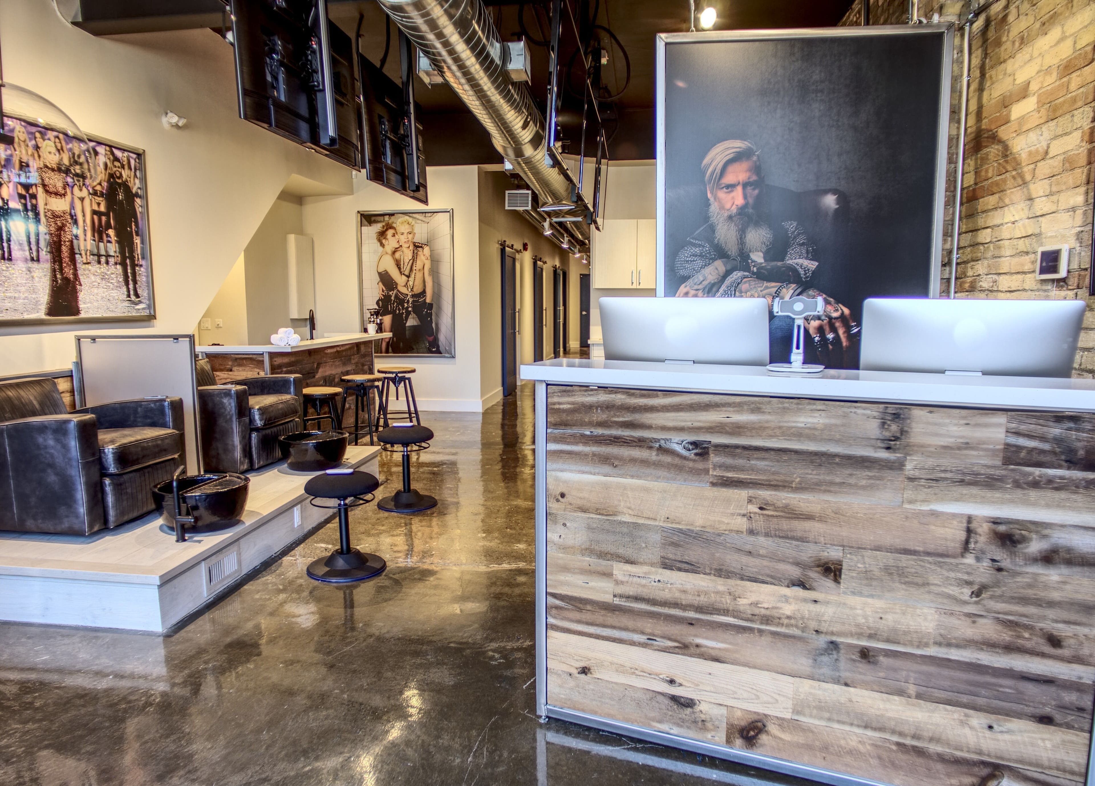 Modern interior of Menicure Queen West in Toronto, Ontario, CA with rustic decor and stylish seating.