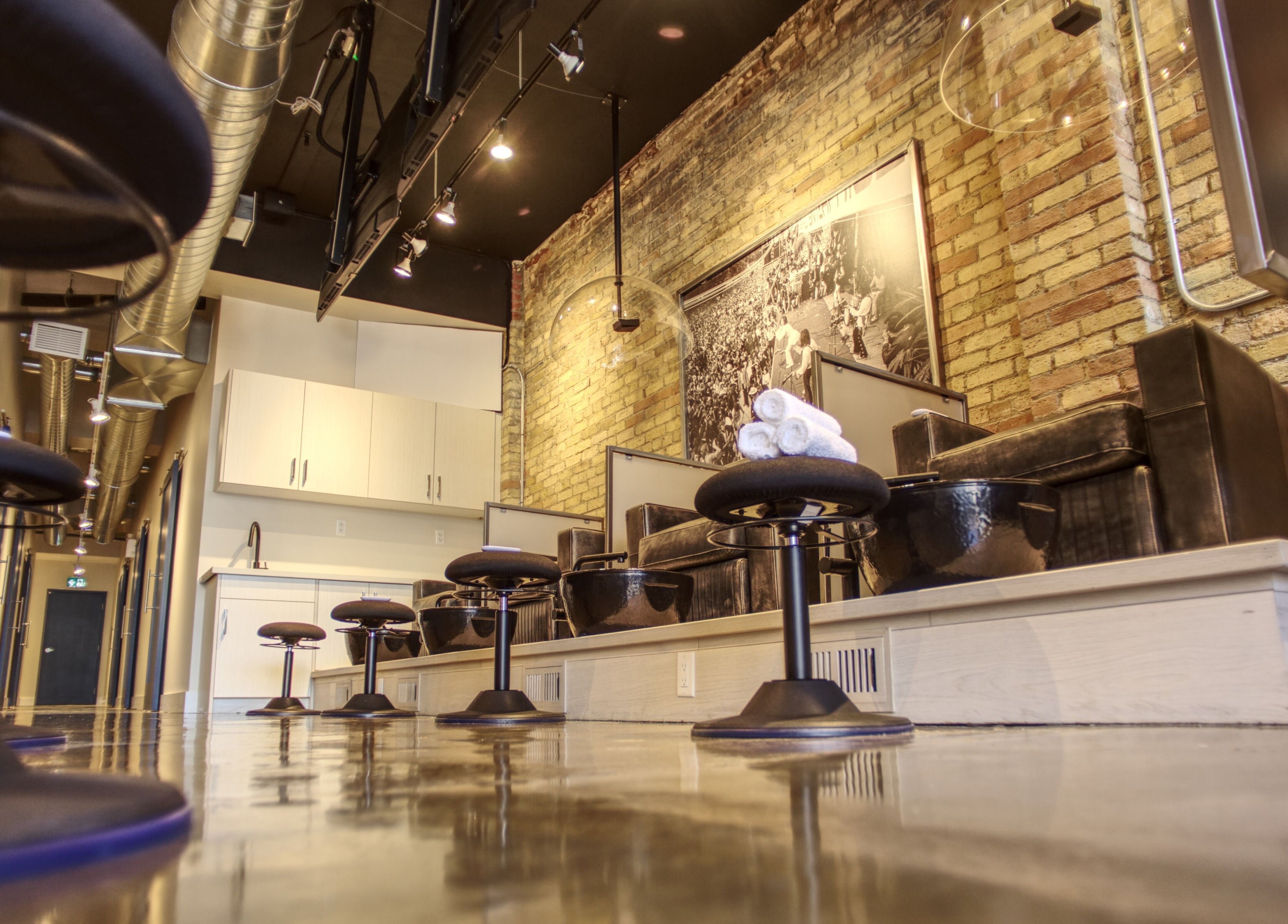 Chic pedicure stations at Menicure Queen West, Toronto, Ontario, CA with sleek modern design.