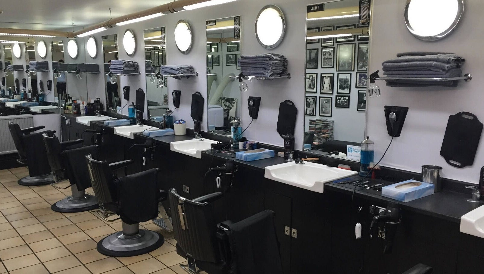 Interior of Leonard and Michael Barbershop in London, England, GB featuring modern styling chairs and mirrors.