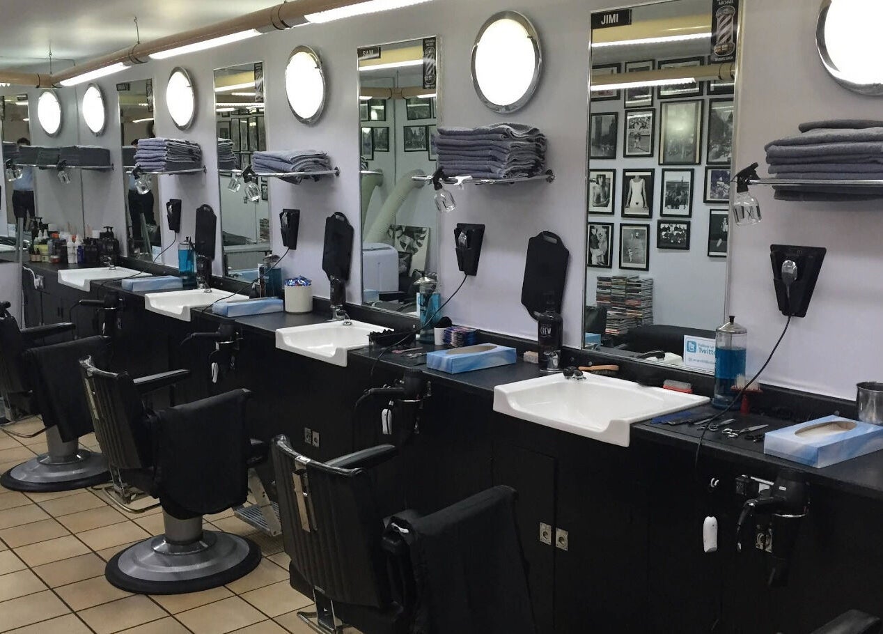 Interior of Leonard and Michael Barbershop in London, England, GB featuring modern styling chairs and mirrors.