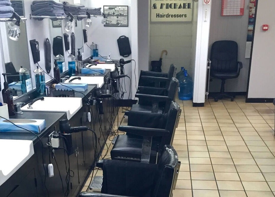 Interior of Leonard and Michael Barbershop in London, England, GB featuring sleek barber chairs and grooming tools.