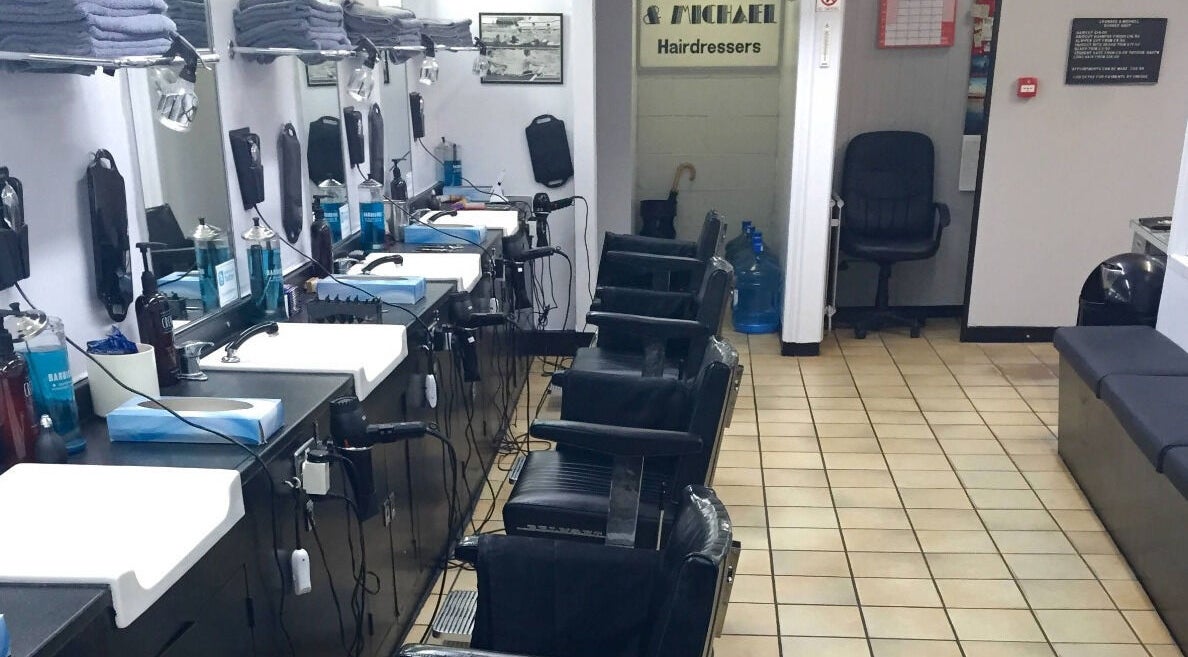 Interior of Leonard and Michael Barbershop in London, England, GB featuring sleek barber chairs and grooming tools.