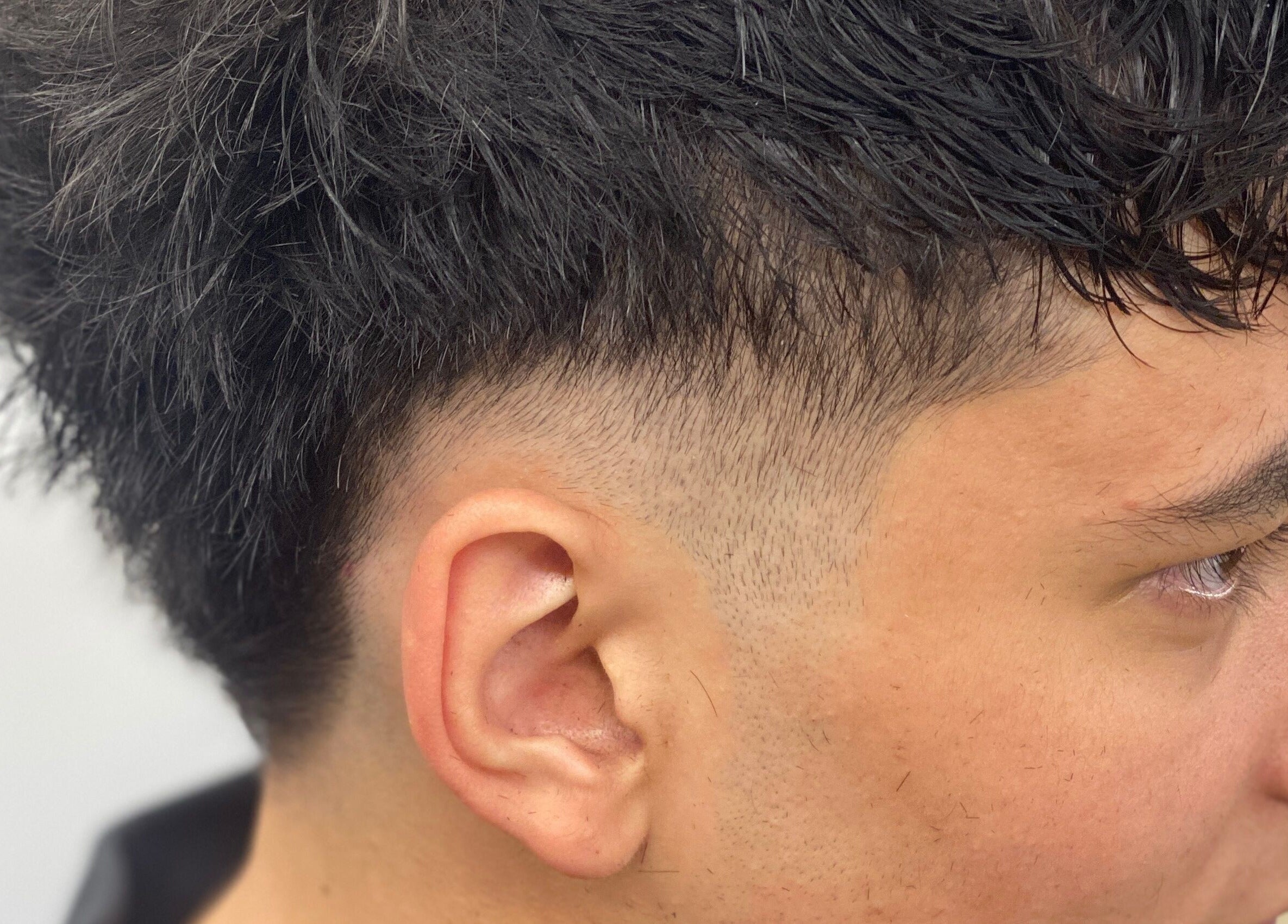 Close-up of clean fade haircut at Leonard and Michael Barbershop, London, England, GB.