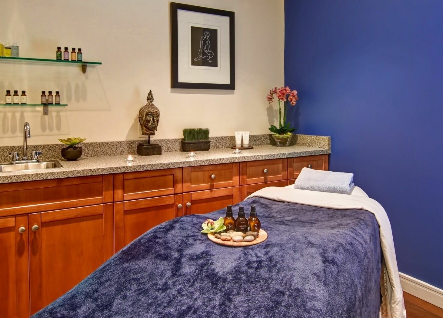 Serene massage room at Five Lakes Spa Aveda, Niagara Falls, Ontario, CA featuring a cozy table and calming decor.