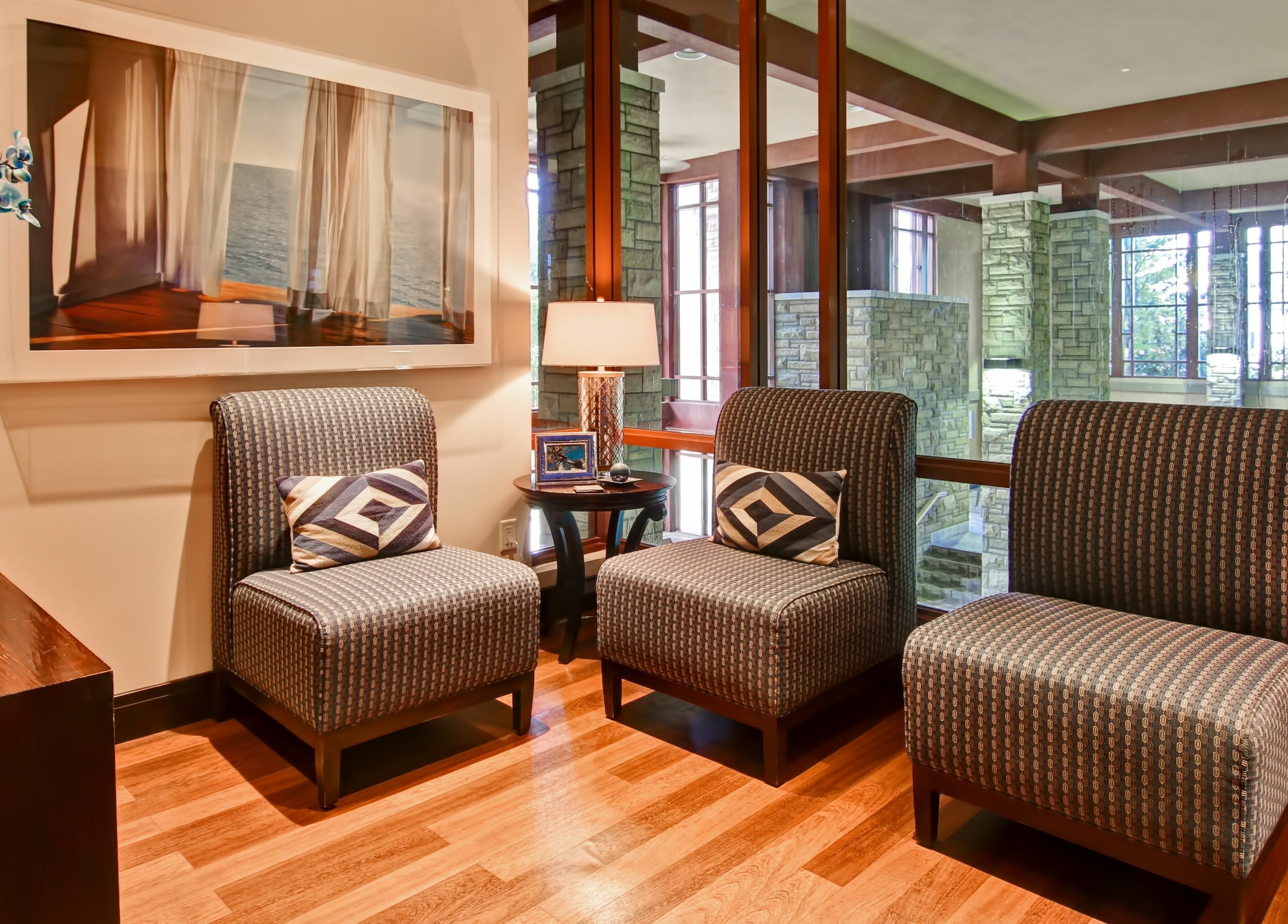 Comfortable seating area at Five Lakes Spa Aveda, Niagara Falls, Ontario, CA with elegant decor and warm lighting.
