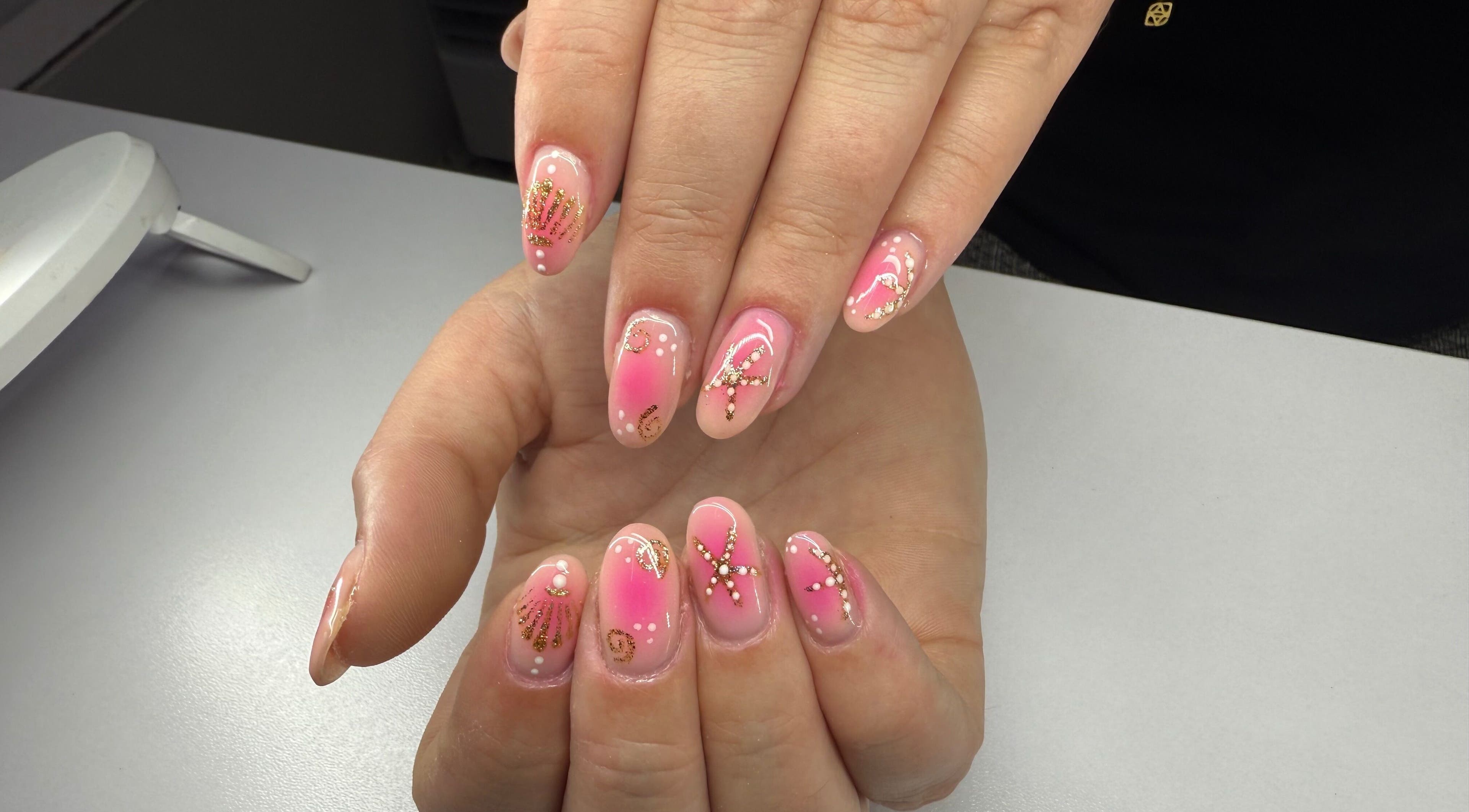 Elegant pink and gold nail art at The Manicurist, Birmingham, England, GB.