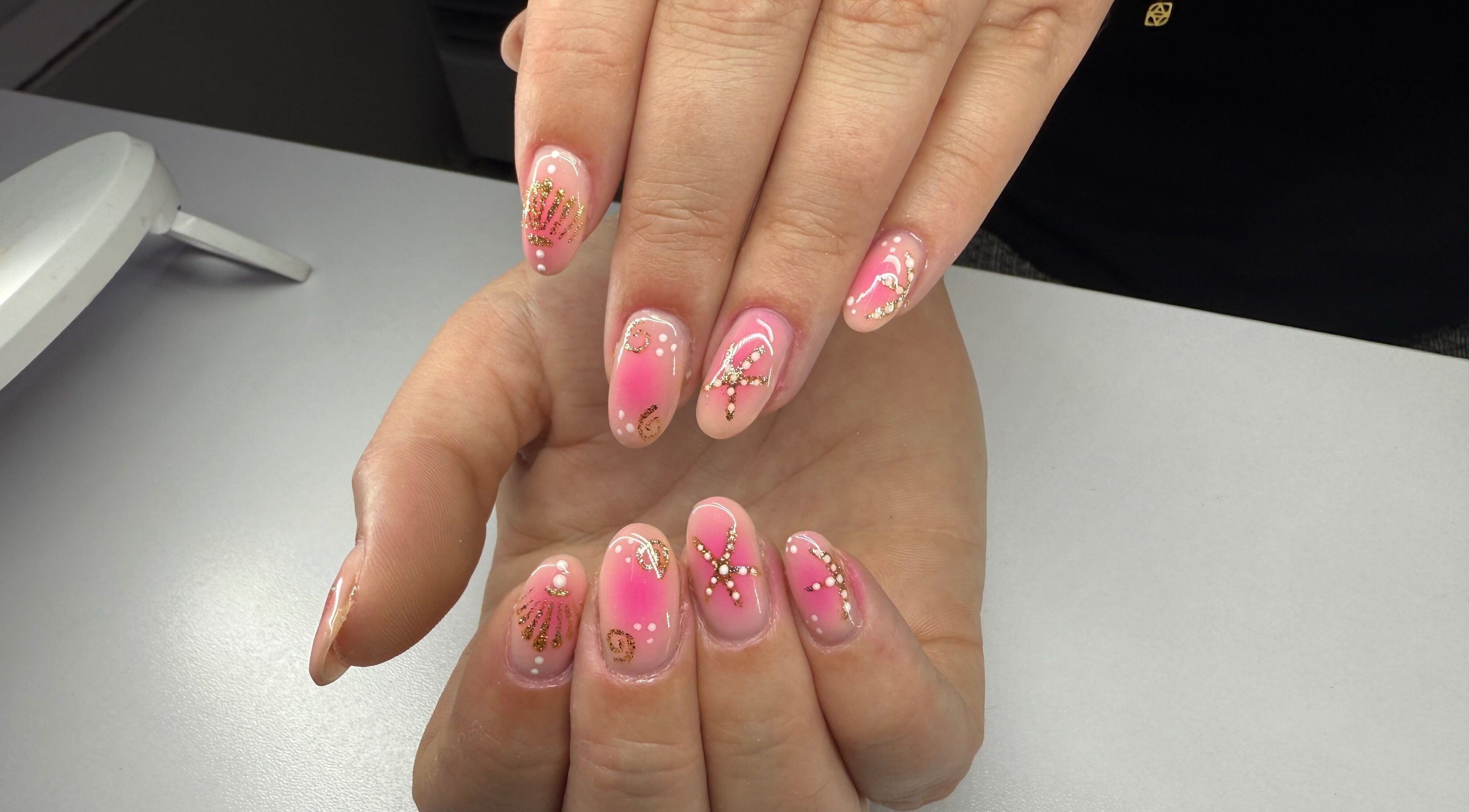 Elegant pink and gold nail art at The Manicurist, Birmingham, England, GB.