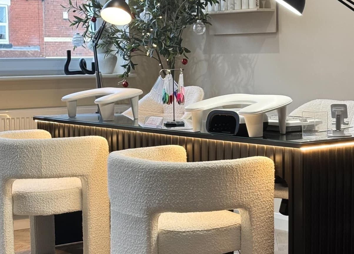 Modern nail care station at The Booth in Shafton, England, GB, featuring plush white chairs and sleek lighting.