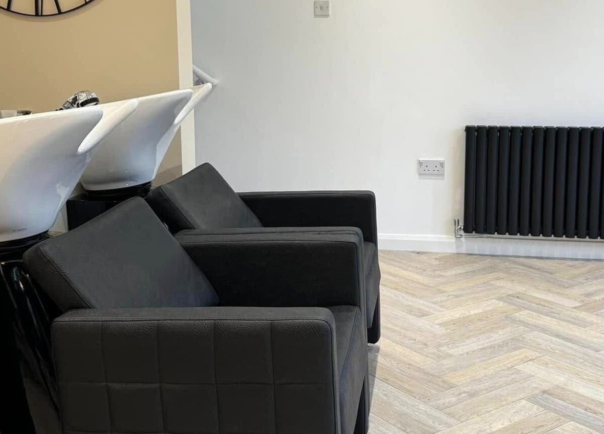 Elegant wash stations with black chairs at The Booth, Shafton, England, GB, offering a stylish ambiance.