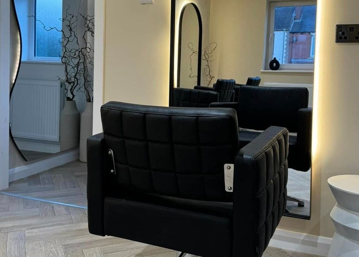 Modern styling chair and mirror at The Booth, Shafton, England, GB, showcasing sleek salon design.