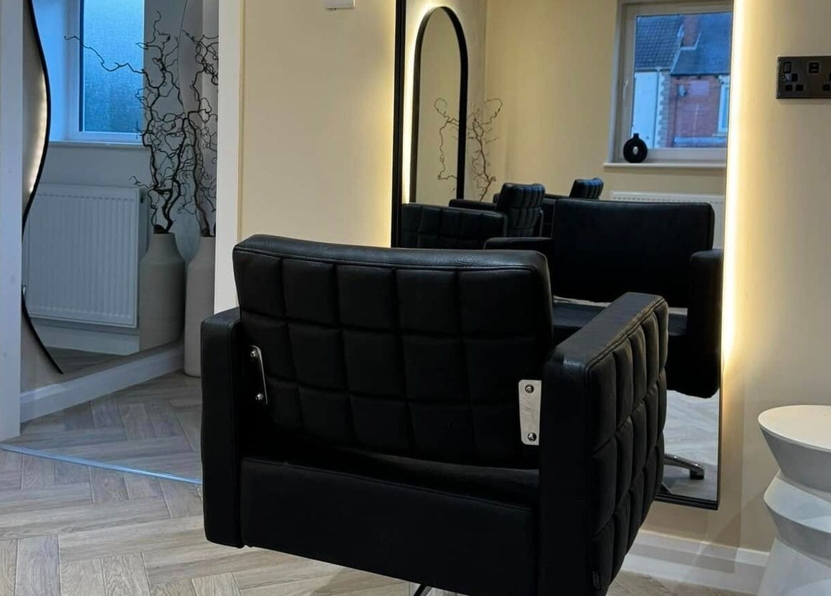 Modern styling chair and mirror at The Booth, Shafton, England, GB, showcasing sleek salon design.