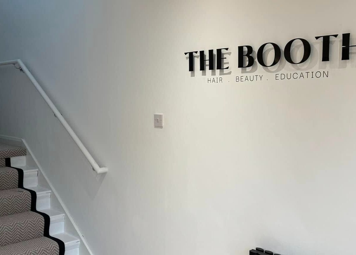 The Booth entrance hallway in Shafton, England, GB with stairs and signage on the wall.